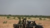FILE - Niger's army soldiers ride on a pickup truck near Agadez, Niger, Oct. 29, 2019.