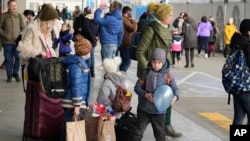 Ukrainian refugees wait for a transport at the central train station in Warsaw, Poland, March 27, 2022. More than 3.7 million people have fled the war so far, Europe’s largest exodus since World War II.