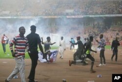 Police fire tear gas to chase pitch invaders at the end of the 2022 Qatar World Cup qualifying match between Ghana and Nigeria, at Moshood Abiola National Stadium, in Abuja, Nigeria, March. 29, 2022