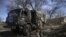 Ukranian troops drive a captured Russian military vehicle after retaken the village of Mala Rogan, East of Kharkiv, on March 28, 2022