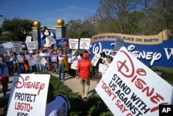 FILE - Advocates march at a rally at the Walt Disney Company, spearheaded by advocates from AIDS Healthcare Foundation, in Orlando, Fla., March 3, 2022. (AP Images for AIDS Healthcare Foundation)