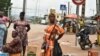 FILE - Street vendors are seen in Noe, a border town between Ivory Coast and Ghana where residents have not been able to cross due to the COVID-19 pandemic, Sept. 22, 2021. 