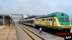 FILE - A man walks past a train of the newly completed Abuja-Kaduna railway line in Abuja, July 21, 2016. 