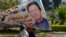 A motorcyclist rides past a billboard with a picture of Pakistan's Prime Minister Imran Khan outside the National Assembly, in Islamabad, Pakistan, April 3, 2022.