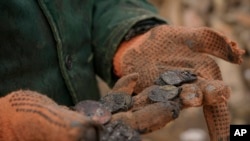 Serhiy Malyshenko, a decorated veteran of the Soviet war in Afghanistan, holds his military medals that he retrieved from the ruins of his house, destroyed during fighting between Russian and Ukrainian forces in the village of Yasnohorodka, on the outskirts of Kyiv, Ukraine, March 30, 2022.