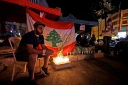 FILE - Lebanese protesters hold a candlelight vigil during anti-government demonstrations in Beirut, Oct. 31, 2019.