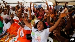 Woman gather at a local market area to celebrate the victory of Ivory Coast's President Alassane Ouattara after elections in Abidjan, Oct. 28, 2015. 