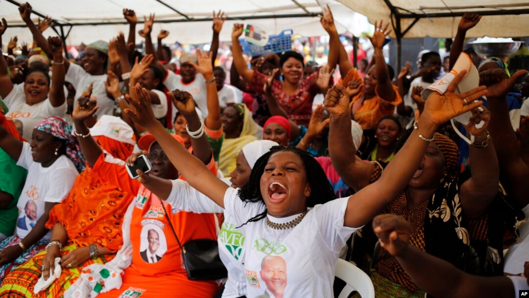 Woman gather at a local market area to celebrate the victory of Ivory Coast's President Alassane Ouattara after elections in Abidjan, Oct. 28, 2015. 