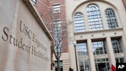 FILE - People enter the University of Southern California's Engemann Student Health Center in Los Angeles, May 22, 2018.