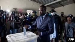 FILE - Ousmane Sonko (C), President of the opposition party Senegalese Patriots for Work, Ethics and Brotherhood (PASTEF), casts his ballot at the HLM basic school in Ziguinchor on July 3, 2022.