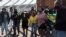 FILE - Protesters demand police investigate the killing of over 20 Black South African allegedly at the hands of vigilante group Durban, South Africa, July 23, 2021.