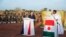 FILE - French President Emmanuel Macron and Niger President Mahamadou Issoufou pay homage to Niger soldiers killed in an attack on a military camp, in Niamey, Niger, Dec. 22, 2019. At least 89 died in another attack Jan. 9 in Chinagodrar..