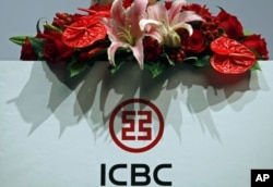 FILE - The company logo of the Industrial and Commercial Bank of China is seen during a news conference announcing its annual results, in Hong Kong, March 29, 2012.