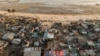 FILE - Debris and destroyed buildings are all that remain after Cyclone Idai hit the Praia Nova neighborhood in Beira, Mozambique, April 1, 2019.