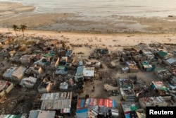 Debris and destroyed buildings are all that remain after Cyclone Idai hit the Praia Nova neighborhood in Beira on April 1, 2019.