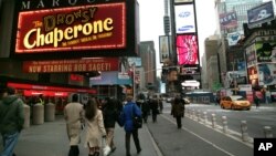 FILE - Time Square displays for musicals are among the lights of Broadway in New York, Nov. 29, 2007. 