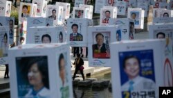 Candidates' posters for the upcoming general elections are hung on strings over the Cheonggye stream in downtown Seoul, South Korea, Monday, April 11, 2016.