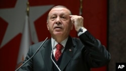 FILE - Turkey's President Recep Tayyip Erdogan addresses to his ruling party's provincial leaders in Ankara, Turkey, Nov. 17, 2017. 