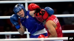 FILE - Philippines's Nesthy Petecio, right, exchanges punches with Japan's Sena Irie at the 2020 Summer Olympics, Tuesday, Aug. 3, 2021, in Tokyo, Japan. (AP Photo/Themba Hadebe)