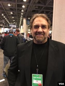 NFL star, former NFL defensive lineman Bob Golic makes the rounds with radio stations and fans at Radio Row for Super Bowl 50, at the Moscone Convention Center in San Francisco, Feb. 5, 2016. (P. Brewer/VOA)