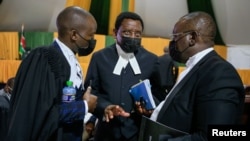 Kenyan Senior Counsel James Orengo, center, confers with lawyers Arnold Ochieng and Paul Mwangi during the ruling in the Building Bridges Initiatives case, at the Court of Appeal in Nairobi, Kenya, Aug. 20, 2021.