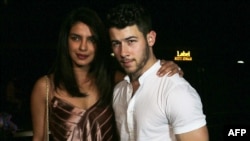 Indian actress Priyanka Chopra (L) and US musician Nick Jonas are pictured after a dinner in Mumbai, Nov. 27, 2018.