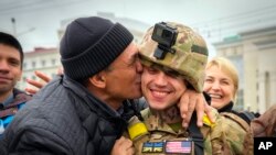 A Kherson resident kisses a Ukrainian soldier in central Kherson, Ukraine, Nov. 13, 2022. 