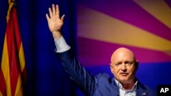 Sen. Mark Kelly, D-Ariz., waves to supporters during an election night event in Tucson, Ariz., Nov. 8, 2022.