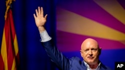 Sen. Mark Kelly, D-Ariz., waves to supporters during an election night event in Tucson, Ariz., Nov. 8, 2022.