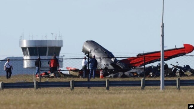 A damaged plane sits at the Dallas Executive Airport in Dallas after two historic military planes collided and crashed on Nov. 12, 2022.