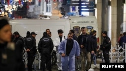 Police officers block the street after an explosion on busy pedestrian Istiklal street in Istanbul, Turkey, Nov. 13, 2022. 