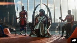 This image released by Marvel Studios shows, from left, Dorothy Steel as Merchant Tribe Elder, Florence Kasumba as Ayo, Angela Bassett as Ramonda, and Danai Gurira as Okoye in a scene from "Black Panther: Wakanda Forever."