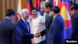 U.S. President Joe Biden greets other leaders during the 2022 ASEAN summit in Phnom Penh, Cambodia, November 12, 2022. 