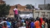 People await a food distribution from a truck aimed to help those affected by the travel restrictions imposed in an attempt to limit the spread of Ebola, in Mubende, Uganda on Nov. 1, 2022. Ugandan health officials said Friday the cases are gradually stabilizing.