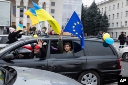 Ukrainians gather in downtown to celebrate the recapturing their city, Kherson, Ukraine, Saturday, Nov. 12, 2022.