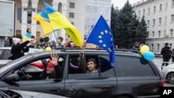 Ukrainians gather in downtown to celebrate the recapturing their city, Kherson, Ukraine, Saturday, Nov. 12, 2022.