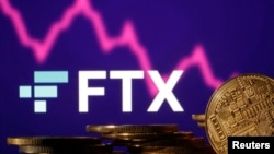 FILE - Representations of cryptocurrencies are seen in front of displayed FTX logo and decreasing stock graph in this illustration taken Nov.10, 2022