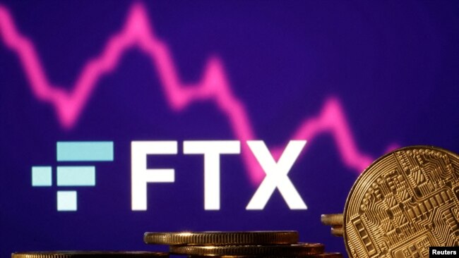 FILE PHOTO: Representations of cryptocurrencies are seen in front of displayed FTX logo and decreasing stock graph in this illustration taken Nov.10, 2022