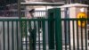 FILE - A paramilitary police officer stands guard outside the German embassy in Beijing, Sept. 6, 2021. 