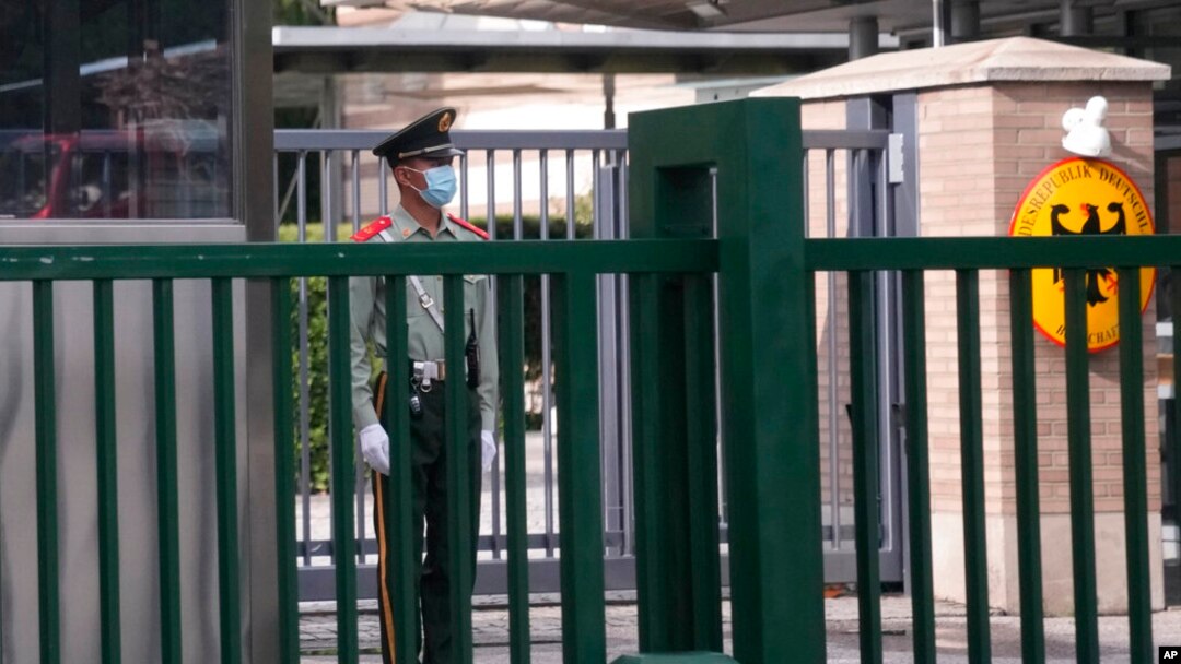 FILE - A paramilitary police officer stands guard outside the German embassy in Beijing, Sept. 6, 2021. 