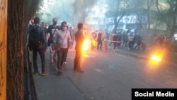 In a screengrab from UGC video posted on social media Nov. 4, 2022, protesters are seen setting fires during an anti-government rally in Tabriz, northwestern Iran.
