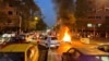 FILE - A police motorcycle burns during a protest over the death of Mahsa Amini, a woman who died after being arrested by the Islamic republic's "morality police", in Tehran, Iran, Sept. 19, 2022.