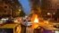 FILE - A police motorcycle burns during a protest over the death of Mahsa Amini, a woman who died after being arrested by the Islamic republic's "morality police", in Tehran, Iran, Sept. 19, 2022.