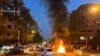 FILE - A vehicle burns during a Sept. 19, 2022 protest of the death of Mahsa Amini, who died after being arrested by "morality police" in Iran. Iran's hardline judiciary has indicted 11 people over the killing of a Basij security force member during unrest, state media reported