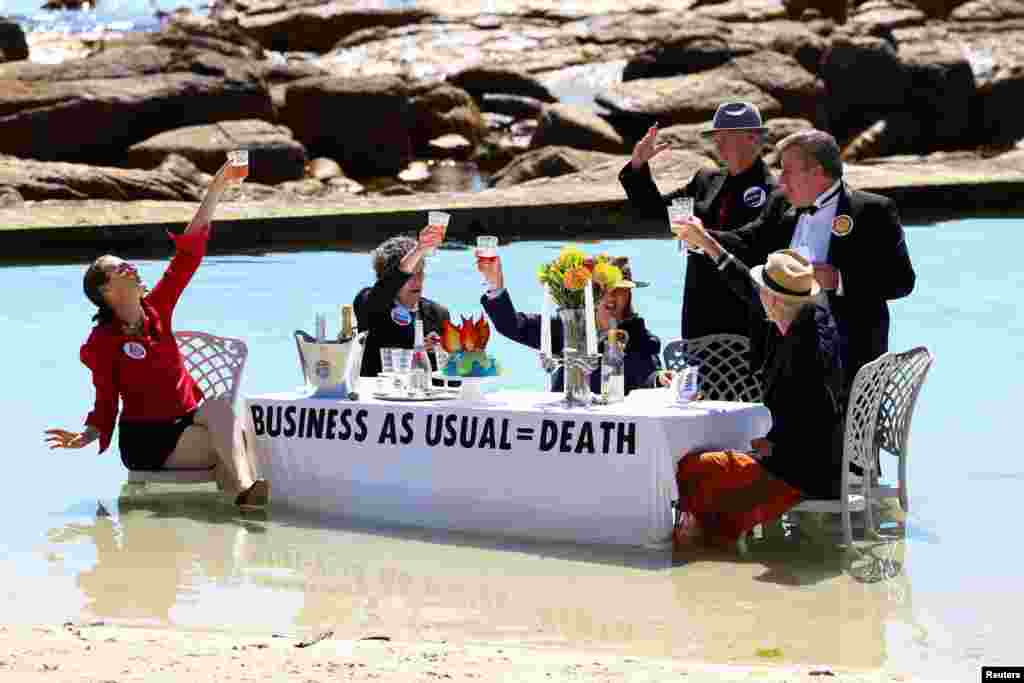 Climate activists from Extinction Rebellion stage a street theatre on a beach during COP27 Water Day, to highlight the fact that fossil fuel &quot;Business as Usual&quot; is leading to climate disasters, such as sea level rise, in Cape Town, South Africa.