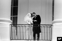 FILE - Newlyweds Luci Baines Johnson and Patrick J. Nugent as they kiss on the White House balcony in Washington, Aug. 6, 1966.