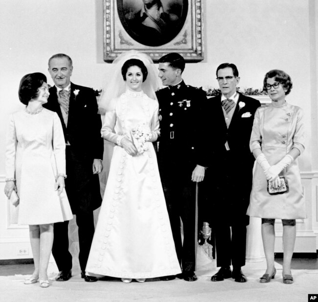 FILE - Newlyweds Marine Corps Capt. Charles S. Robb and Lynda Bird Johnson, center, pose for a photo with their parents in the Yellow Oval Room in the White House in Washington on Dec. 9, 1967.