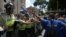 FILE - Supporters of Venezuela's opposition (R) face riot police officers who are blocking a street, as they take part in a rally to demand a referendum to remove Venezuela's President Nicolas Maduro, in Caracas, Venezuela, Sept. 16, 2016. 