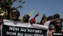 FILE — Senegalese protesters from civil society platform AAR SUNU Election hold a march to protest against the postponement of the presidential election that was scheduled for February 25 in Dakar, Senegal February 17, 2024. 