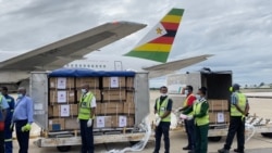 Health officials load 200,000 Sinopharm COVID-19 vaccine doses, donated by China, into a government truck at the Robert Gabriel Mugabe International Airport in Harare, Feb. 15, 2021. (Columbus Mavhunga/VOA)